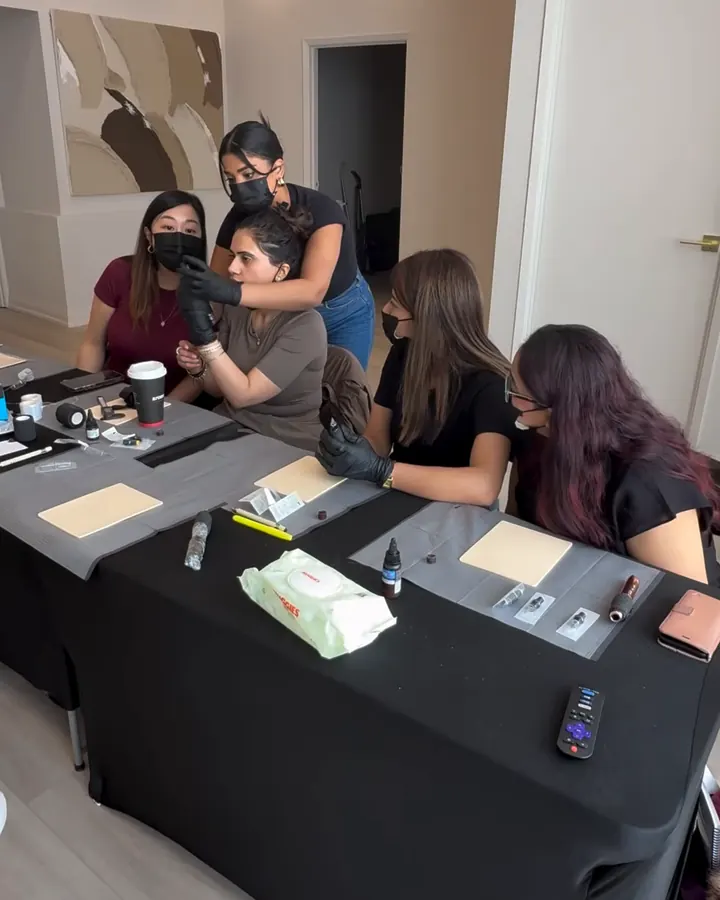 A small group of SKINEAV Academy students practising at the training table in the Vaughan clinic