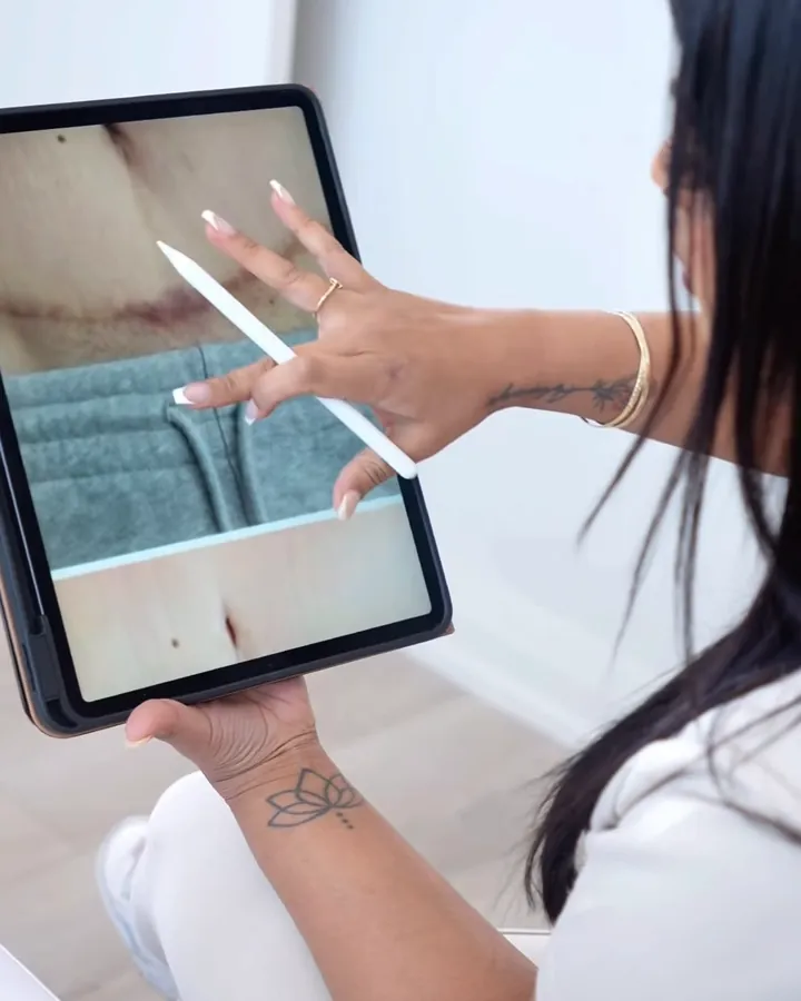 Evelyn showing a client's progress photos on a tablet